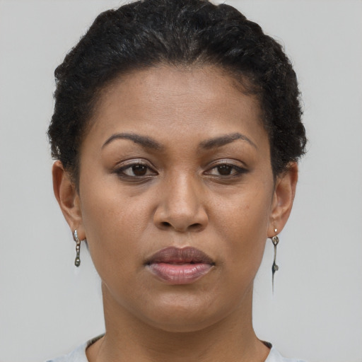 Joyful black young-adult female with short  brown hair and brown eyes