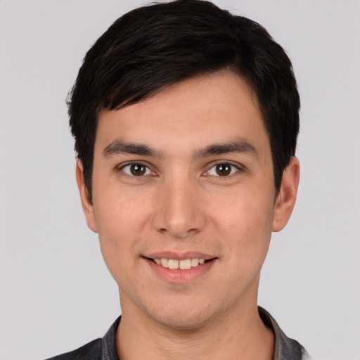 Joyful white young-adult male with short  black hair and brown eyes