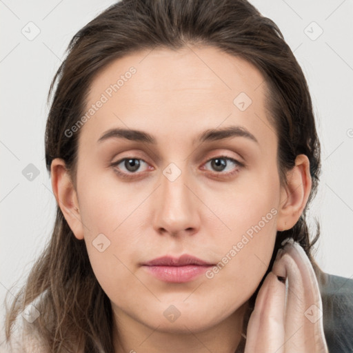 Neutral white young-adult female with long  brown hair and brown eyes