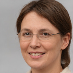 Joyful white adult female with medium  brown hair and brown eyes