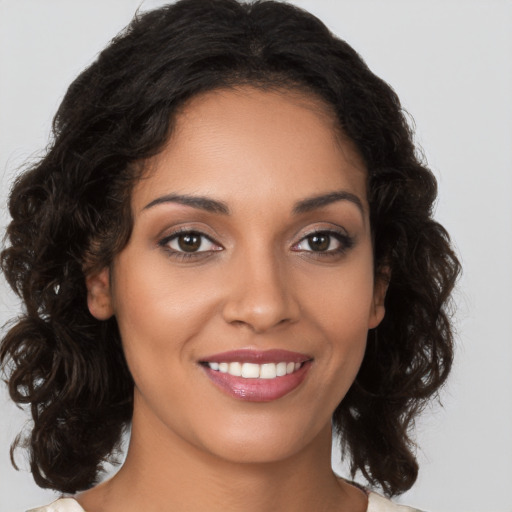 Joyful latino young-adult female with long  brown hair and brown eyes