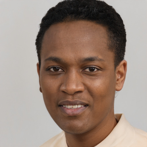 Joyful black young-adult male with short  black hair and brown eyes