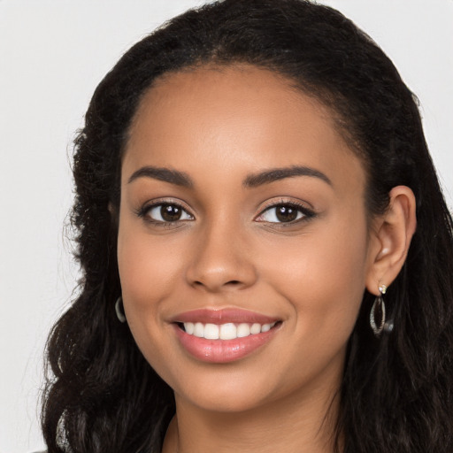 Joyful latino young-adult female with long  black hair and brown eyes