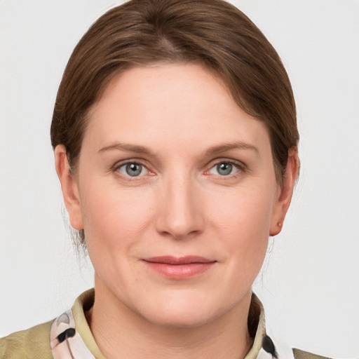 Joyful white young-adult female with medium  brown hair and grey eyes