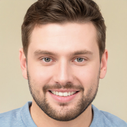 Joyful white young-adult male with short  brown hair and brown eyes