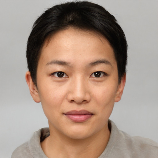 Joyful asian young-adult female with short  brown hair and brown eyes