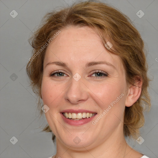 Joyful white adult female with medium  brown hair and blue eyes