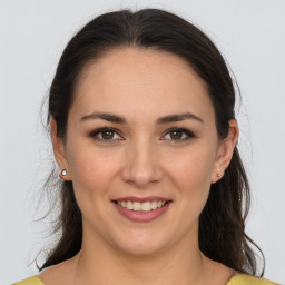 Joyful white young-adult female with medium  brown hair and brown eyes