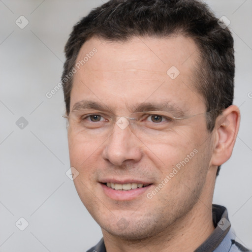 Joyful white adult male with short  brown hair and brown eyes