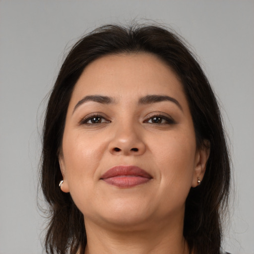 Joyful latino young-adult female with medium  brown hair and brown eyes
