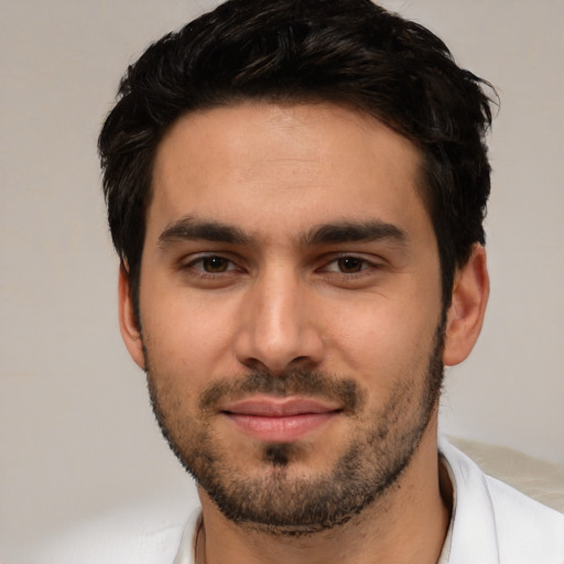 Joyful white young-adult male with short  black hair and brown eyes