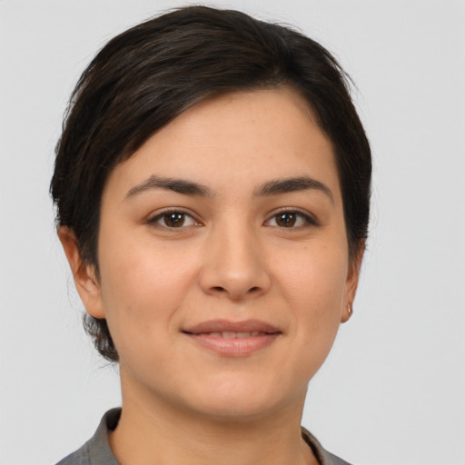 Joyful latino young-adult female with short  brown hair and brown eyes