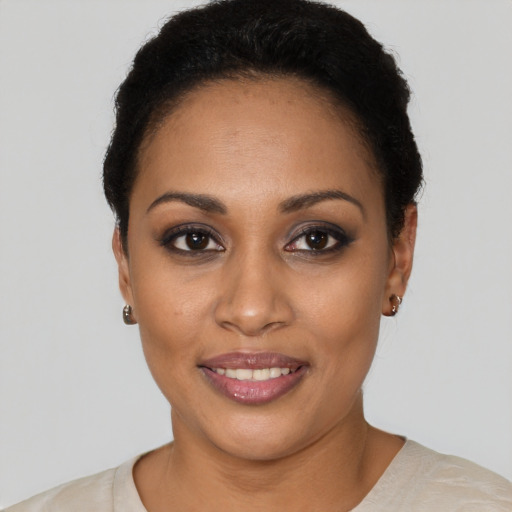 Joyful latino young-adult female with short  black hair and brown eyes