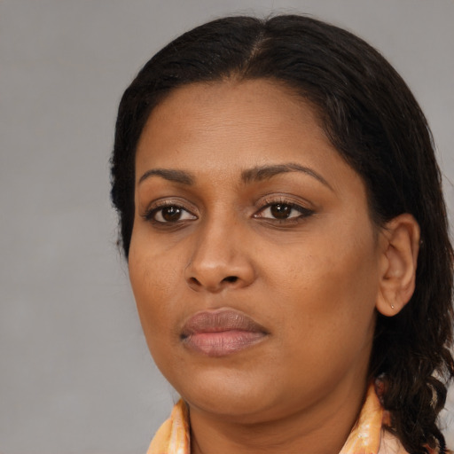 Neutral black young-adult female with long  brown hair and brown eyes