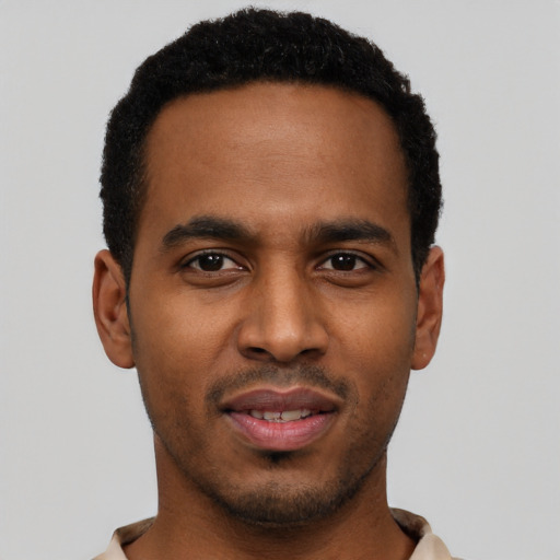 Joyful black young-adult male with short  black hair and brown eyes