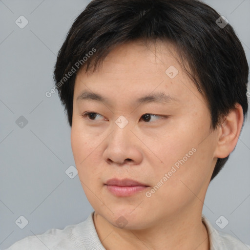 Joyful asian young-adult male with short  brown hair and brown eyes