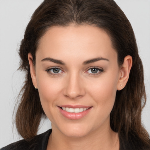 Joyful white young-adult female with medium  brown hair and brown eyes