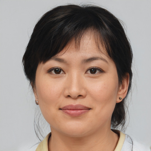 Joyful asian adult female with medium  brown hair and brown eyes