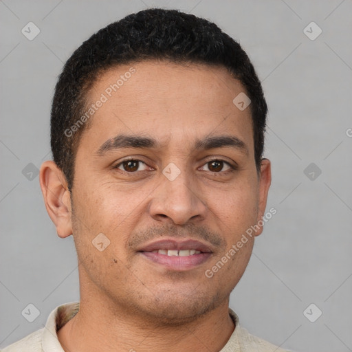 Joyful latino young-adult male with short  brown hair and brown eyes