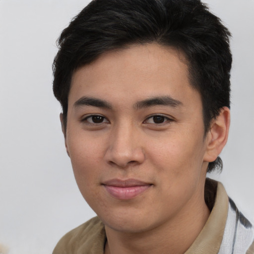 Joyful asian young-adult male with short  brown hair and brown eyes