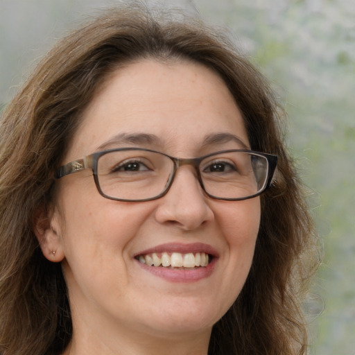 Joyful white adult female with long  brown hair and brown eyes