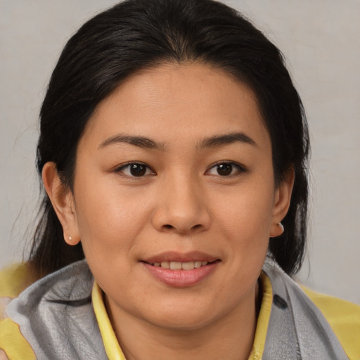 Joyful asian young-adult female with medium  brown hair and brown eyes
