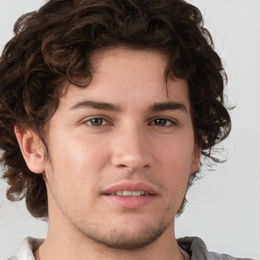 Joyful white young-adult male with medium  brown hair and brown eyes