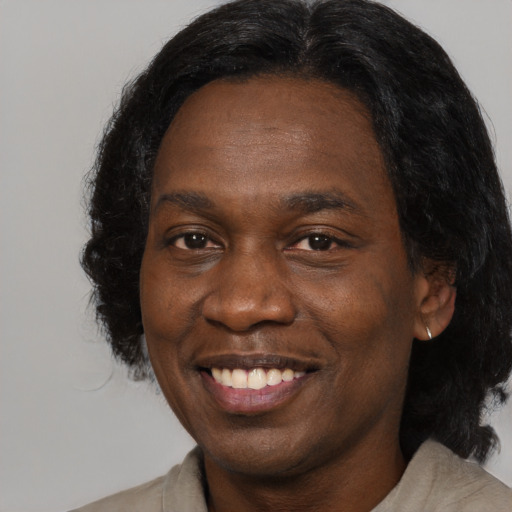 Joyful black young-adult male with medium  black hair and brown eyes