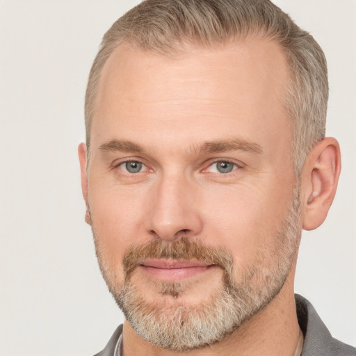 Joyful white adult male with short  brown hair and grey eyes