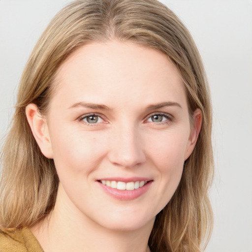 Joyful white young-adult female with long  brown hair and blue eyes