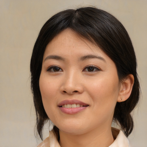 Joyful asian young-adult female with medium  brown hair and brown eyes