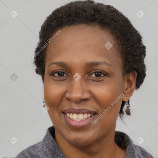 Joyful black adult female with short  brown hair and brown eyes