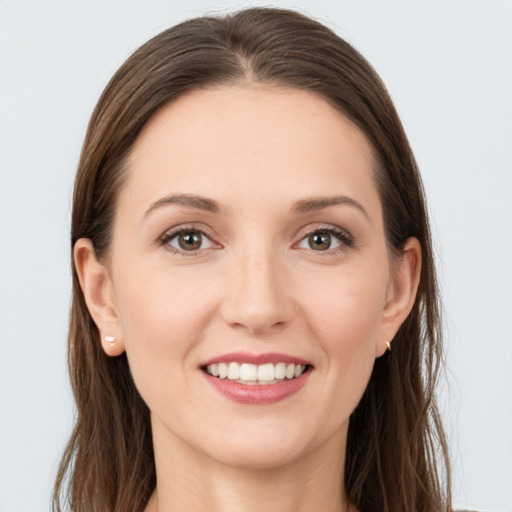 Joyful white young-adult female with long  brown hair and grey eyes