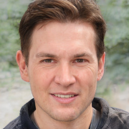 Joyful white adult male with short  brown hair and grey eyes