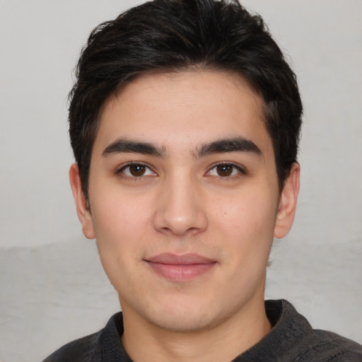 Joyful white young-adult male with short  black hair and brown eyes
