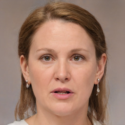 Joyful white adult female with medium  brown hair and grey eyes