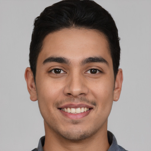 Joyful white young-adult male with short  black hair and brown eyes