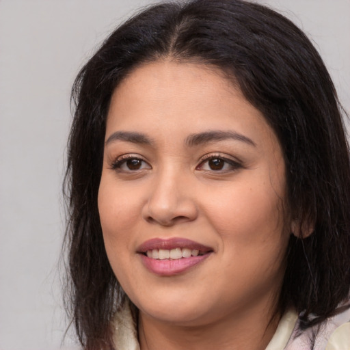 Joyful asian young-adult female with long  brown hair and brown eyes