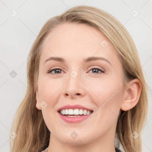 Joyful white young-adult female with medium  brown hair and blue eyes