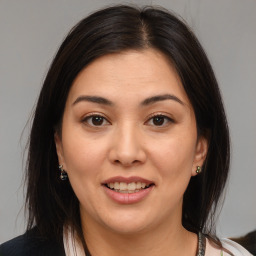 Joyful white young-adult female with medium  brown hair and brown eyes