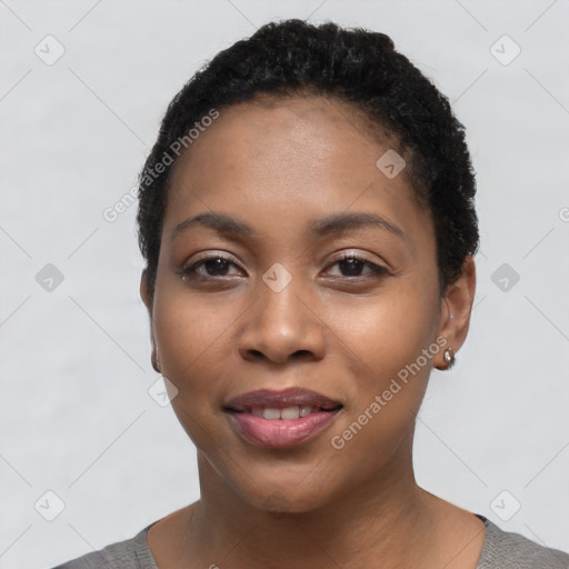 Joyful black young-adult female with short  black hair and brown eyes