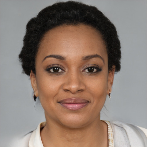 Joyful black young-adult female with short  brown hair and brown eyes