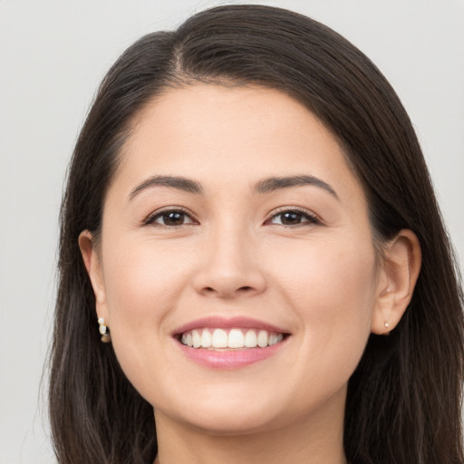 Joyful white young-adult female with long  brown hair and brown eyes