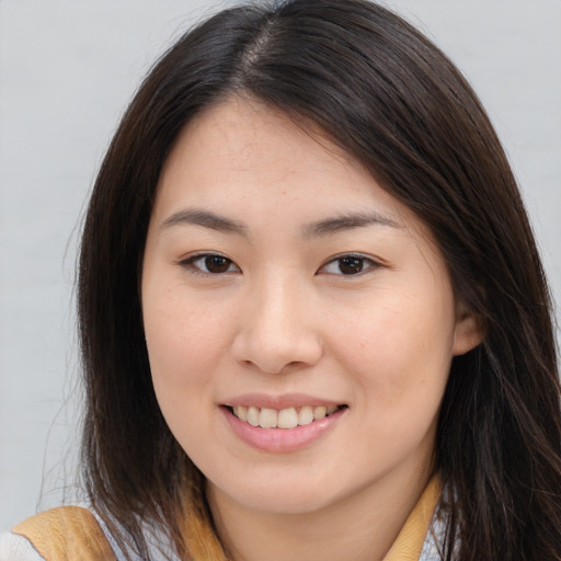Joyful asian young-adult female with long  brown hair and brown eyes