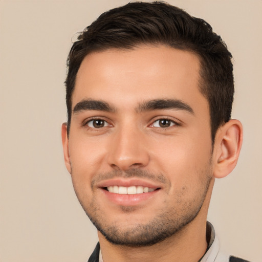 Joyful white young-adult male with short  black hair and brown eyes