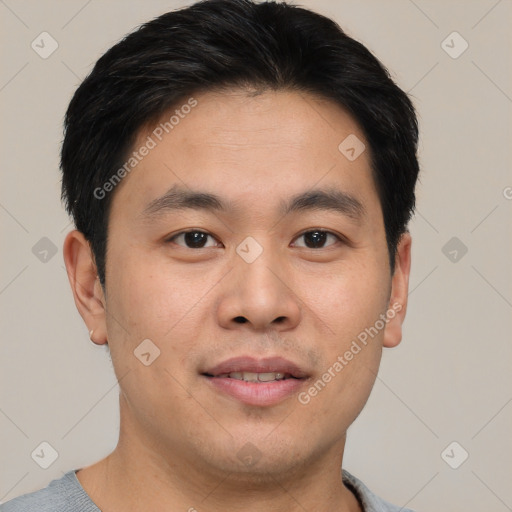 Joyful asian young-adult male with short  black hair and brown eyes