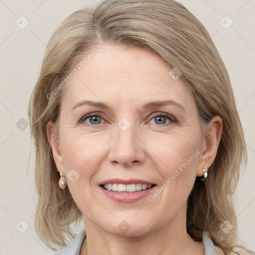 Joyful white adult female with medium  brown hair and grey eyes