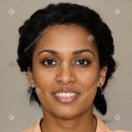 Joyful black young-adult female with short  black hair and brown eyes