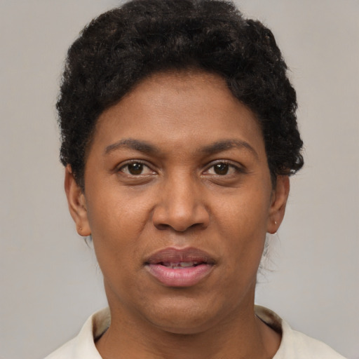 Joyful black adult female with short  brown hair and brown eyes