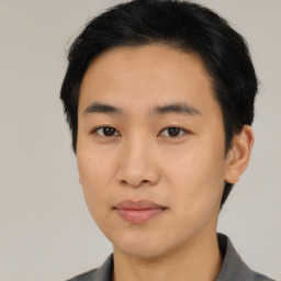 Joyful asian young-adult male with short  brown hair and brown eyes